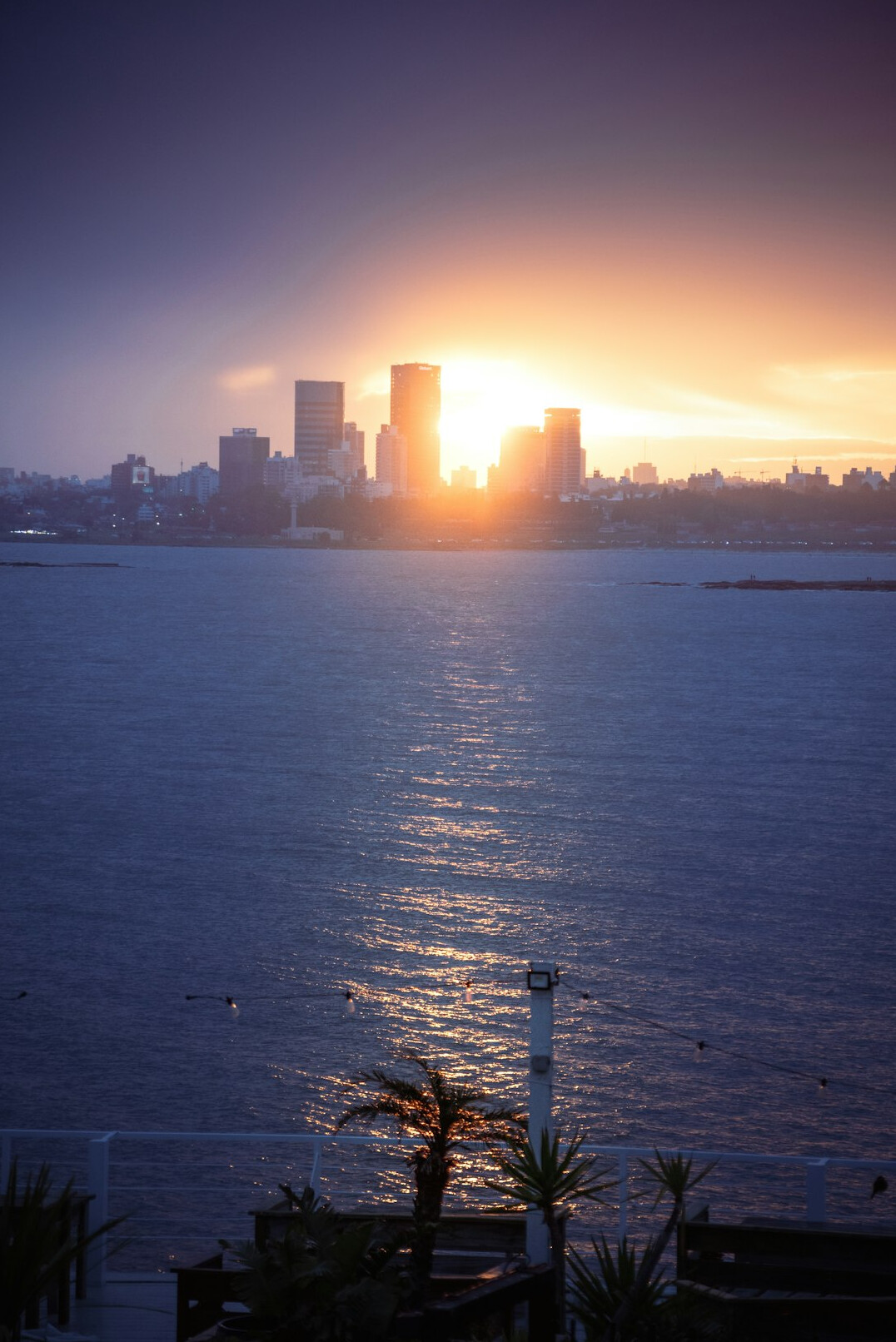 Montevideo waterfront promenade at sunset with city skyline